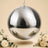 Silver disco ball hanging with cream roses and floral decor on beige background
