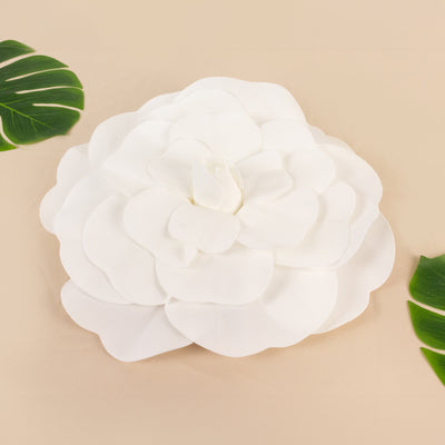 White flower decor on beige background with green leaves.