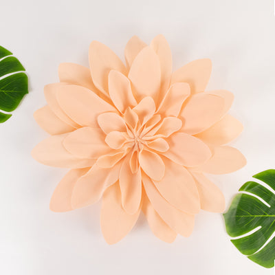 Peach flower wall decor with green leaves on a white background