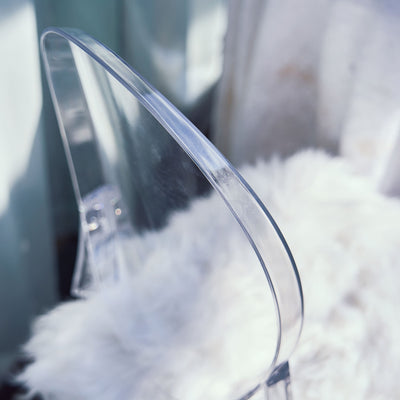 Transparent chair detail on soft white fur