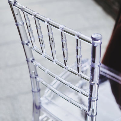 Clear acrylic chair back detail on a light surface.