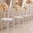 Elegant wedding reception with clear chairs, blush rose centerpieces, and candlelit tables