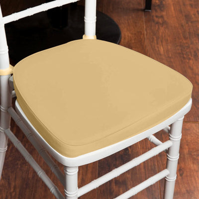 Beige chair cushion on a white chair against a wooden floor.