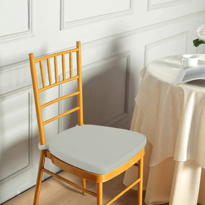 Yellow wooden chair with a light gray cushion in a cozy setting.