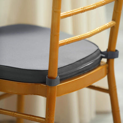 Gray chair cushion on a bamboo chair with straps for secure fit.