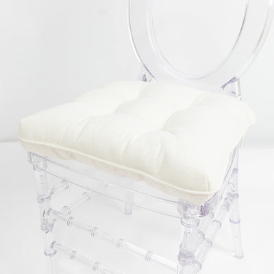 White cushioned clear acrylic chair on white background