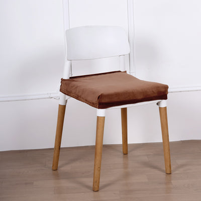 Modern chair with a white backrest and brown cushion on wooden legs.
