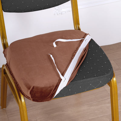 Brown triangular chair cushion with ties on a gold chair.