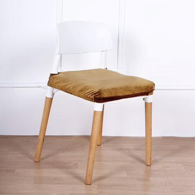 White chair with a brown cushion on a plain backdrop.