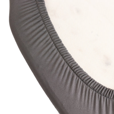 Gray fitted sheet edge on a white background.