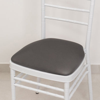White chair with a gray cushion on a plain background.