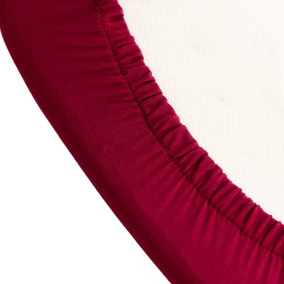 Maroon elastic edge of a fabric round basket on a white background