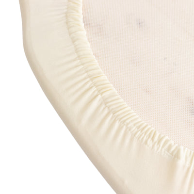 Soft beige fitted sheet with elastic edges for a snug fit.