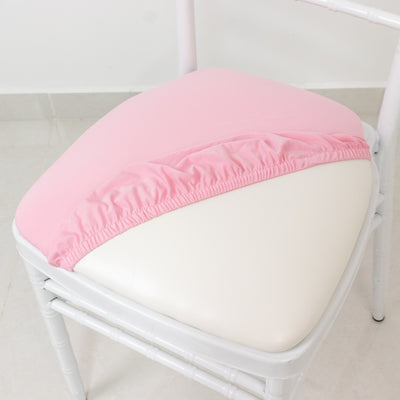 Pink chair cushion cover on a white chair seat.