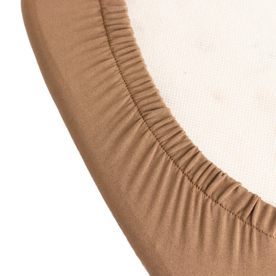 Brown fabric elastic edge detail on a circular surface.
