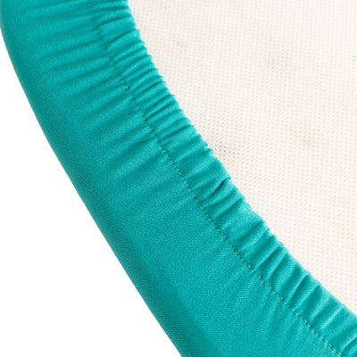 Teal elastic edge of a fabric surface in a clean studio shot.