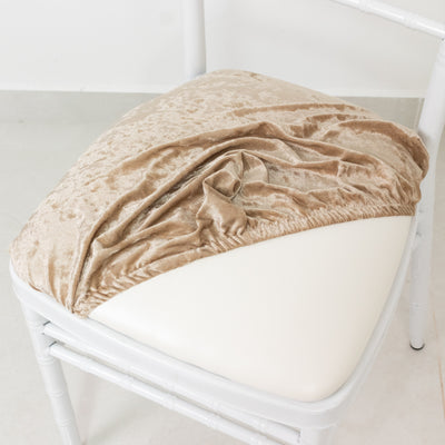 Velvet chair cover draped on a white chair cushion.