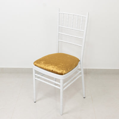 White chiavari chair with a gold velvet cushion