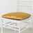 Gold velvet chair cushion on a white rustic chair.