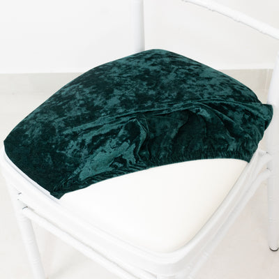 Green velvet chair cushion cover on a white chair.