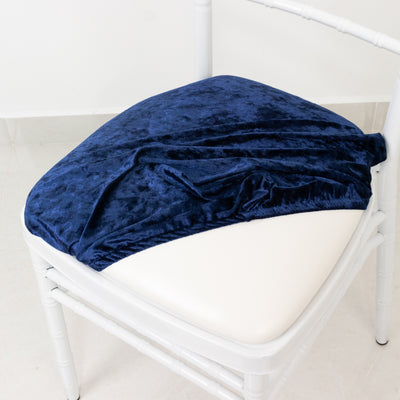 Navy blue velvet chair cover on a white chair