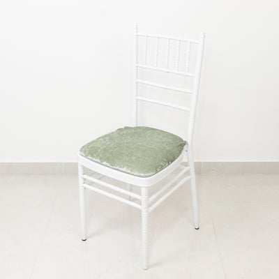 White chair with green cushion on a plain background