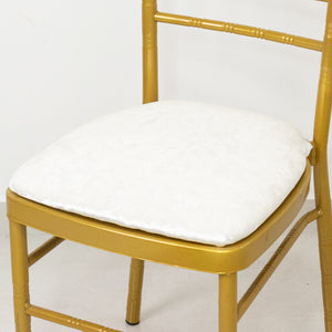 Gold chiavari chair with a plush white cushion