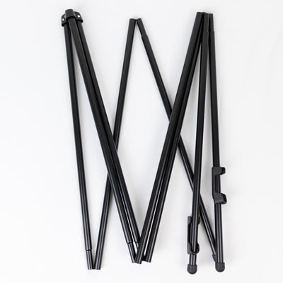 Black folding tripod legs on a white background.