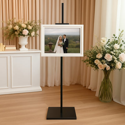 Wedding photo on an easel stand in a stylish interior setting.