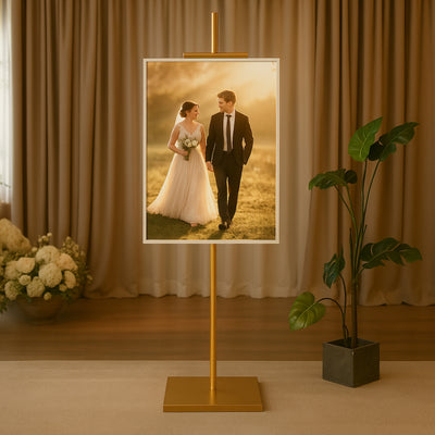 Elegant wedding couple portrait displayed on a stand in a stylish setting.
