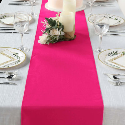 Bright pink table runner on a beautifully set dining table with elegant decor.