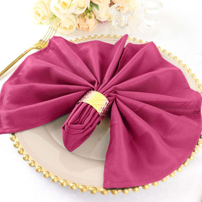 Elegant burgundy napkin artfully arranged on a decorative plate.