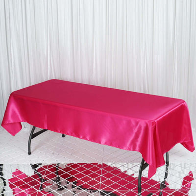 Pink satin tablecloth draped over a rectangular table.