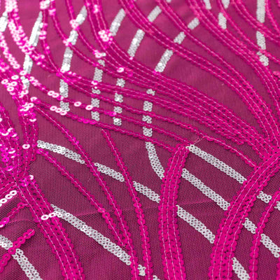 Pink sequined fabric with intricate wave patterns.