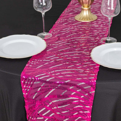 Pink sequin table runner on black table with plates and glasses.