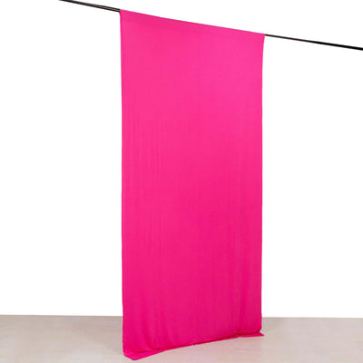 Bright pink fabric backdrop draped vertically on a rod