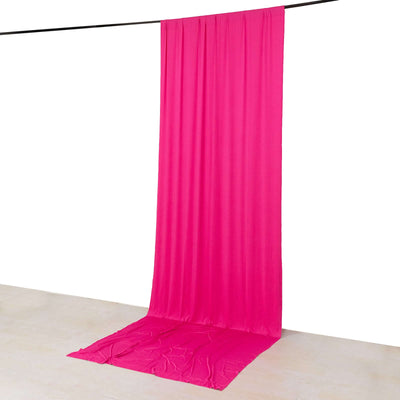 Pink fabric backdrop hanging from a rod for photography or decoration purposes.