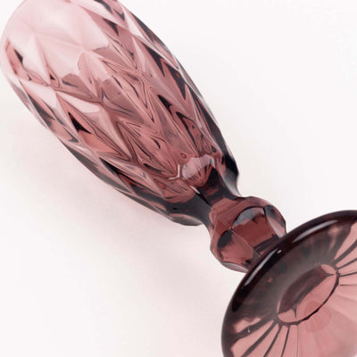 Pink crystal glass goblet with intricate diamond cut design