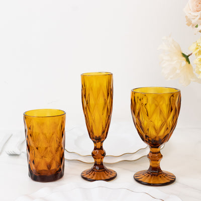 Set of three amber glassware pieces on a white background.