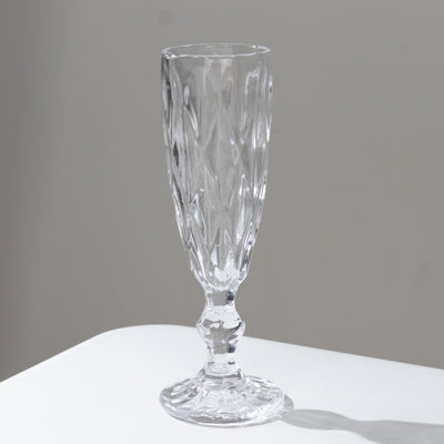 Elegant crystal champagne flute on a plain background
