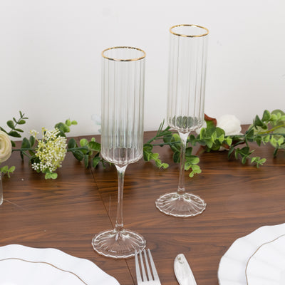 Elegant glass flutes with gold rims, perfect for celebrations.
