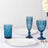 Blue glassware set with white plates on a table