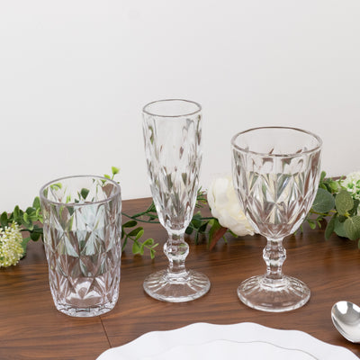Three elegant glassware pieces displayed on a wooden table.