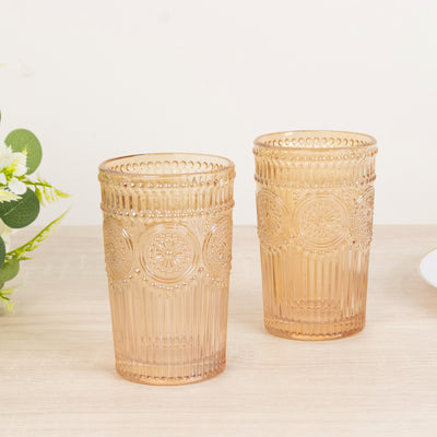 Two vintage-style amber glasses with embossed patterns