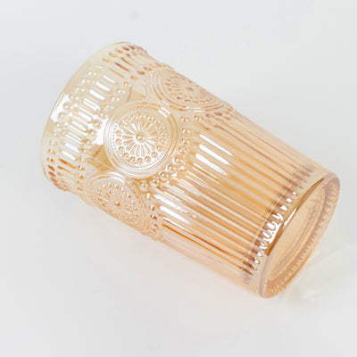 Decorative pink glass tumbler with embossed pattern details