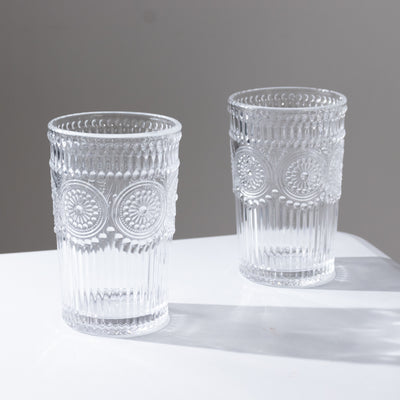 Set of elegant crystal glasses with embossed design.