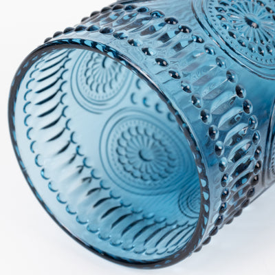 Blue patterned glass tumbler, showcasing intricate design and texture.