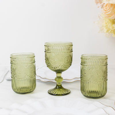 Green textured glassware set of three on a marble surface.