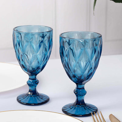 Set of two elegant blue glass goblets with diamond pattern.