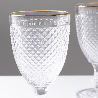 Diamond-patterned crystal goblet with elegant gold rim.